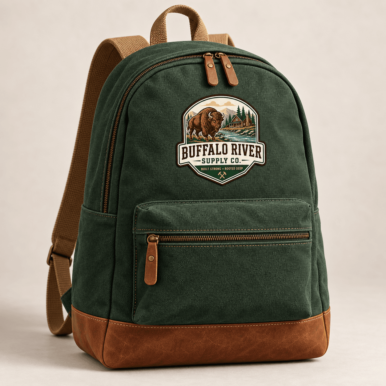 Forest canvas backpack with tan straps, leather details, and the full Buffalo River Supply Co. scenic patch